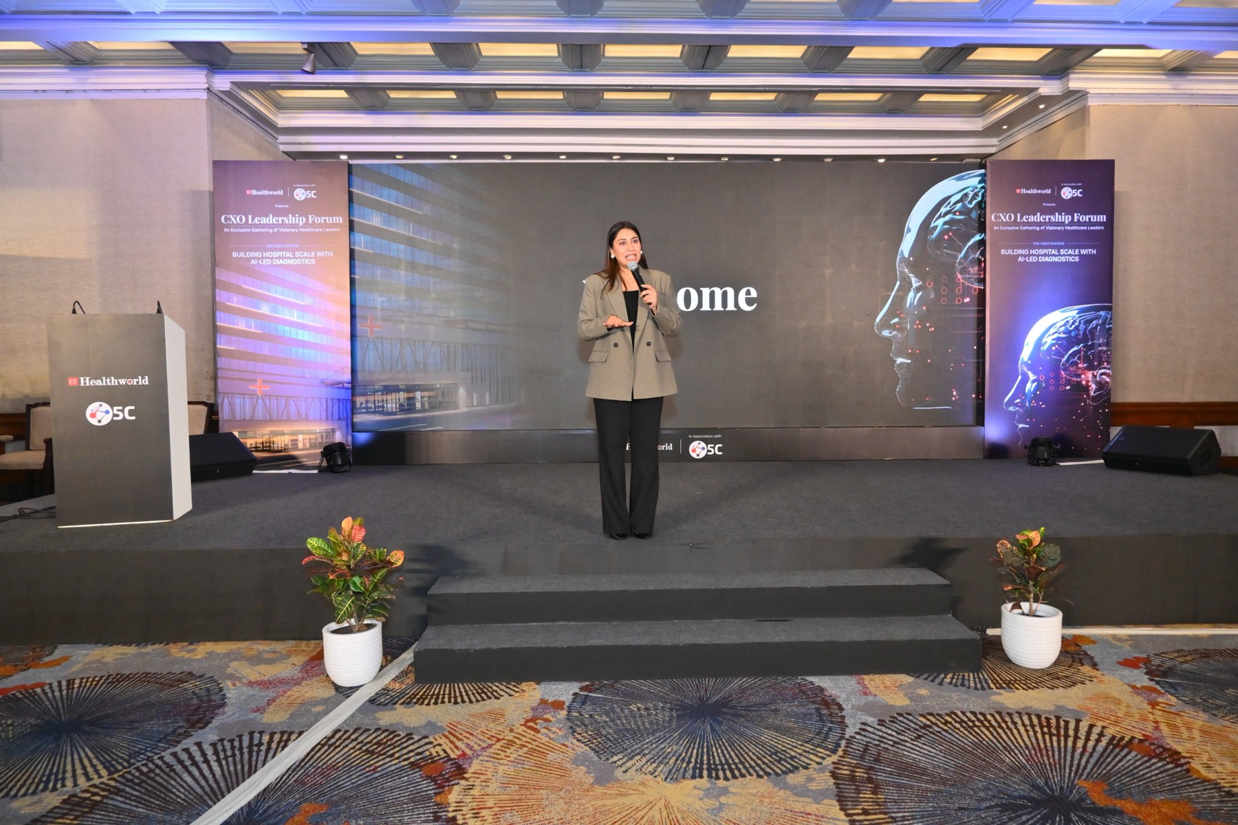 The host opening the evening on the forum stage.