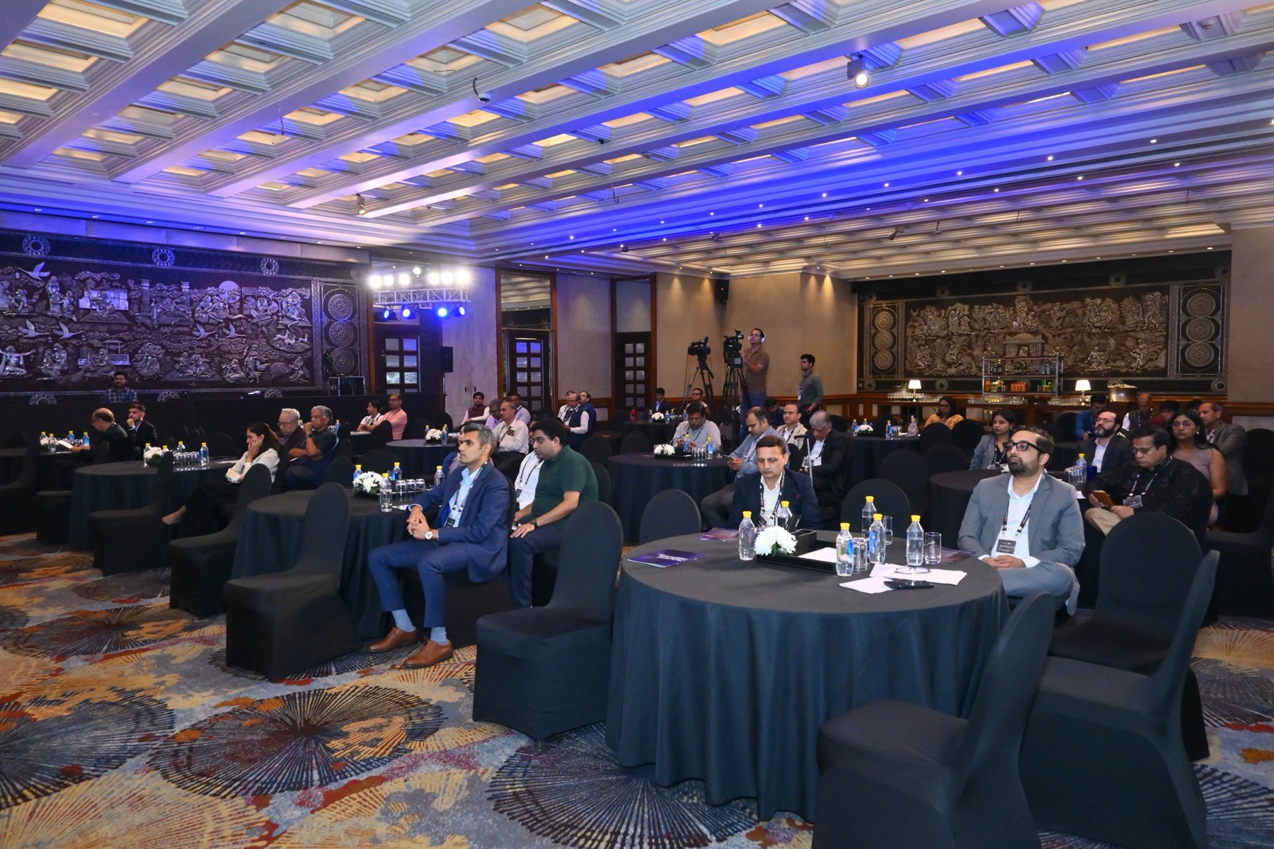 The audience seated at round tables.