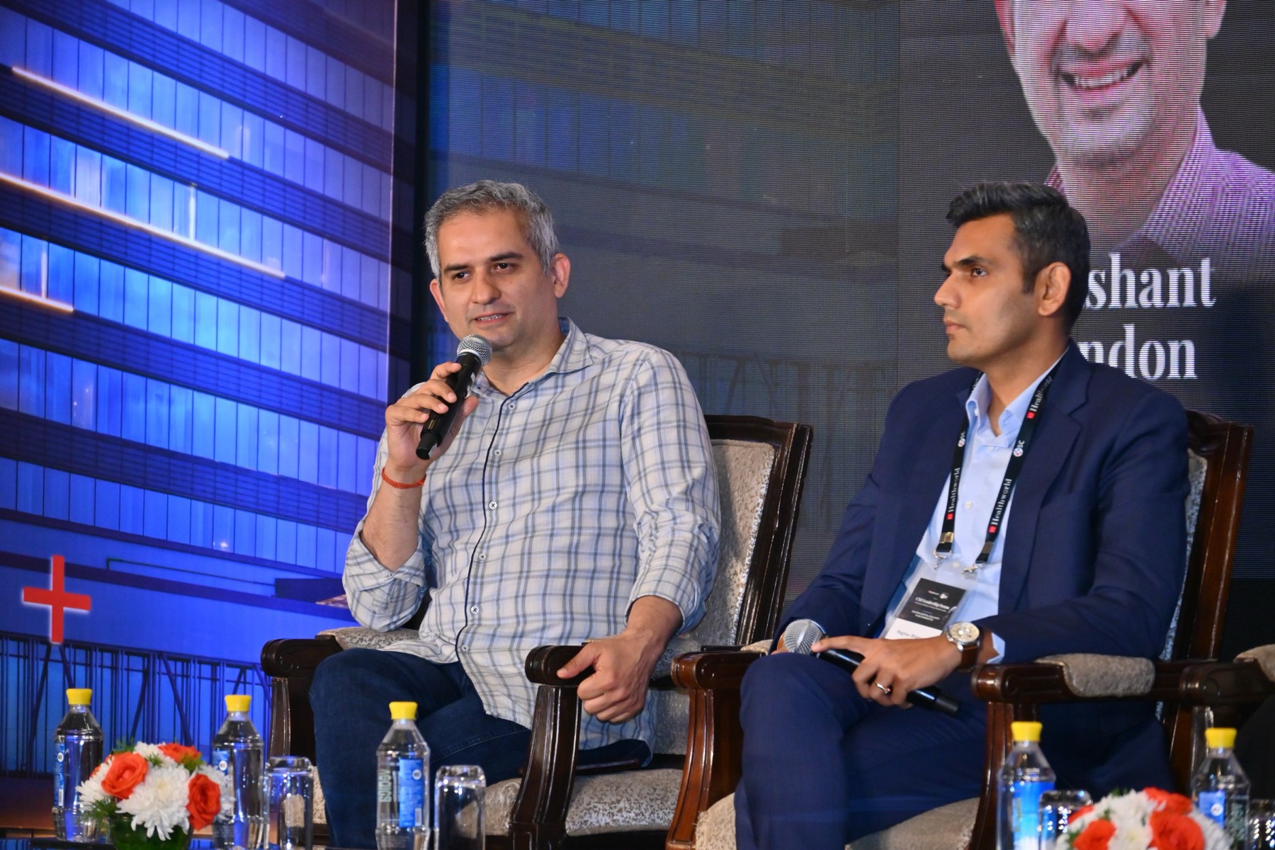 Two panelists in discussion on stage.